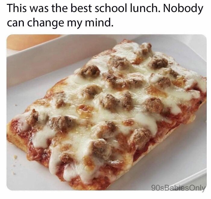 Close-up of nostalgic school lunch pizza slice with cheese and sausage