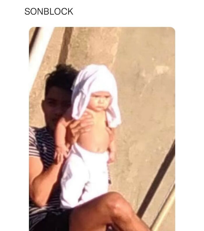 Random meme showing a man holding a baby with a shirt covering its head
