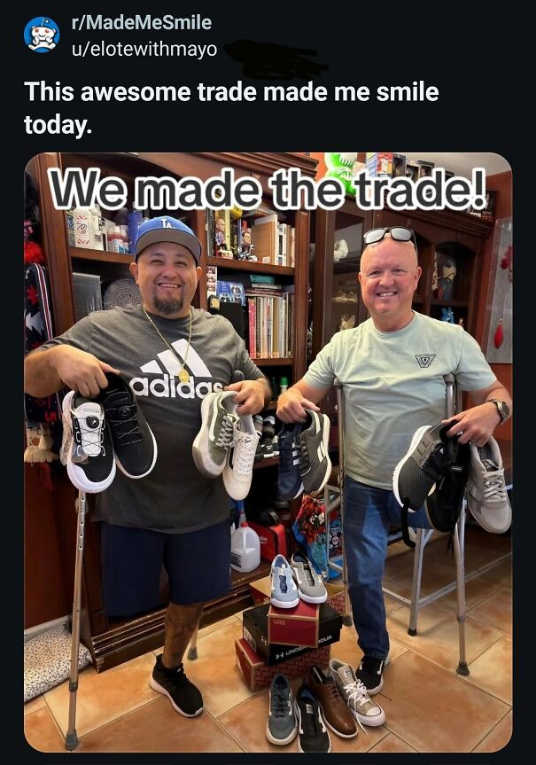 Two men, one using a crutch, smiling and holding pairs of shoes from an awesome trade. Positive posts to make your day!
