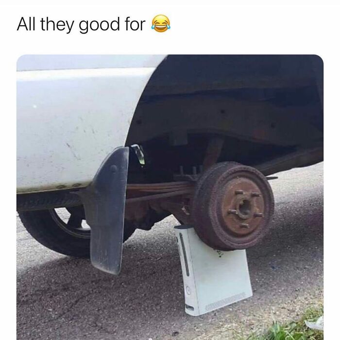 Humorous image of a car wheel supported by an Xbox console