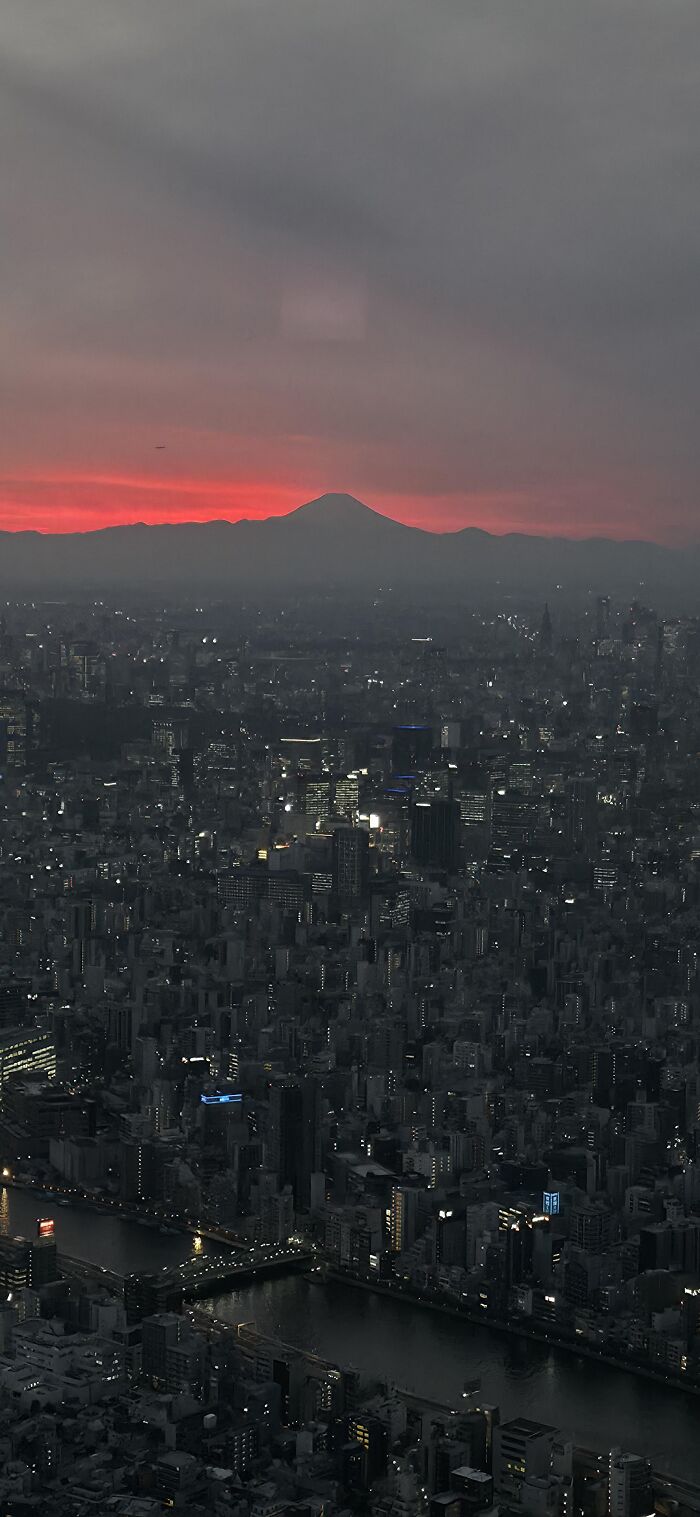 Rare sunset view with silhouette of mountain and city skyline at dusk