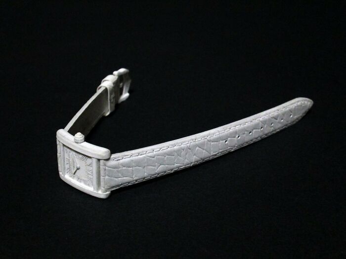 Paper model of a wristwatch with textured leather strap
