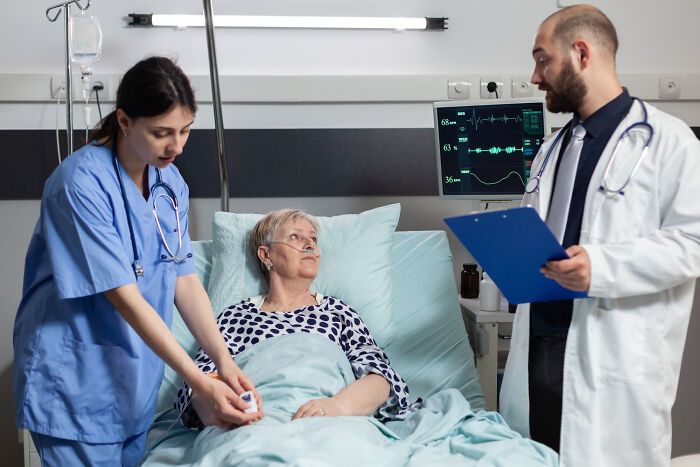 Doctors attending elderly patient in hospital representing conspiracy theory moments explained by facts