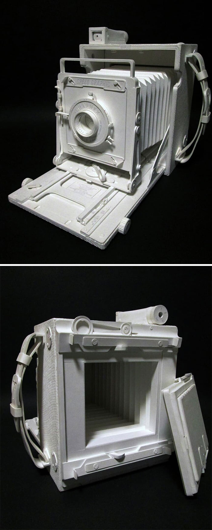 Paper vintage large format camera with bellows extended and front lens detail