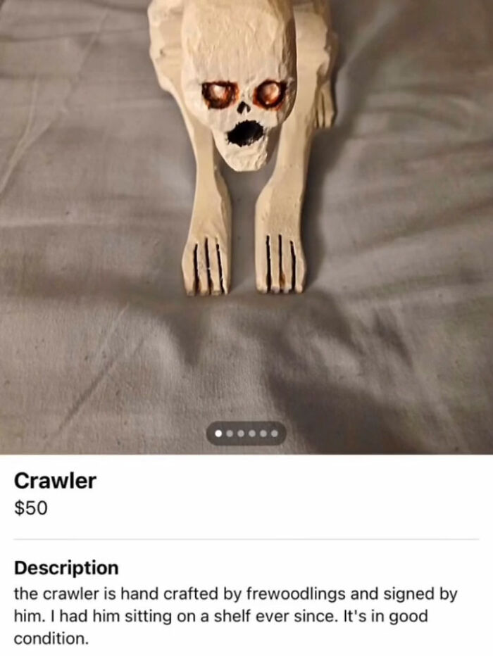 Handcrafted wooden skeleton crawler sculpture with orange eyes