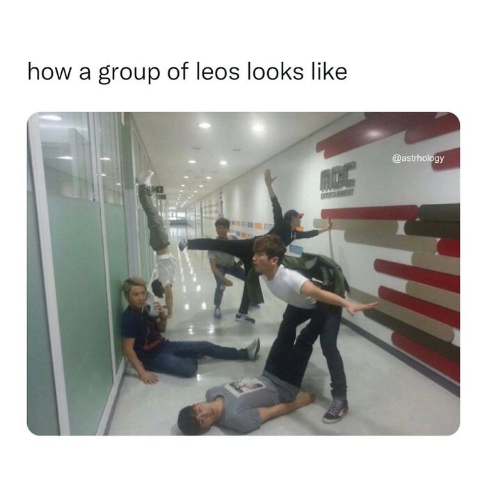 A group of men in a hallway, striking funny poses. One is doing a handstand. Relatable funny astrology memes for zodiac signs.