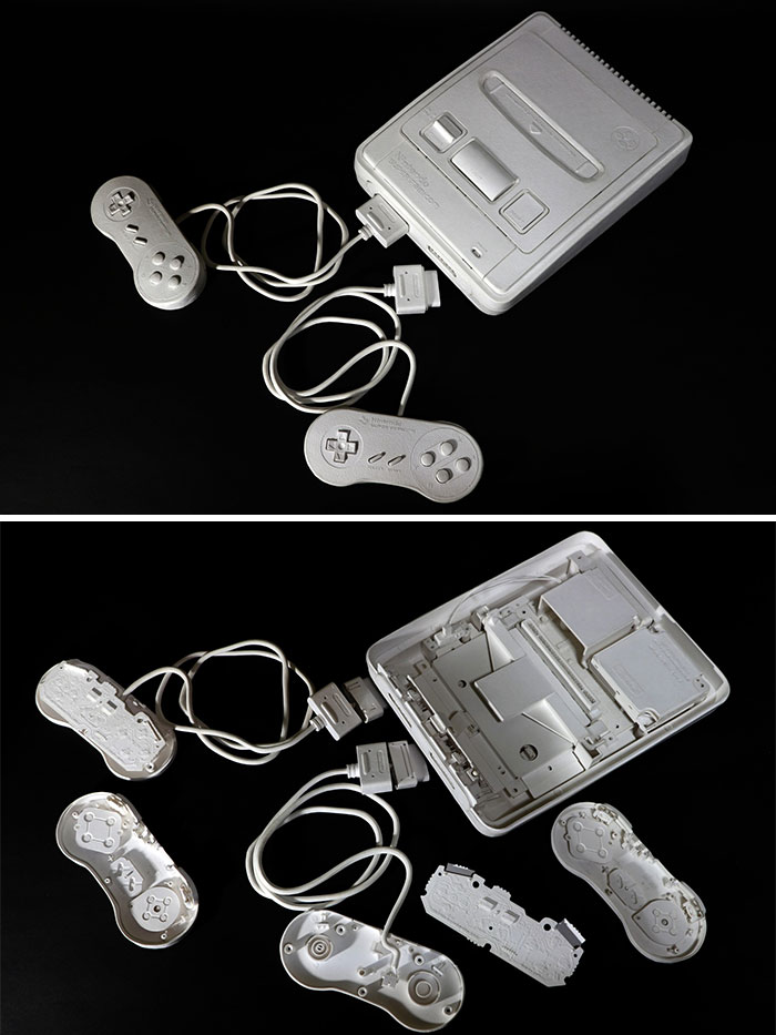Paper Nintendo console and controllers with open back showing circuitry