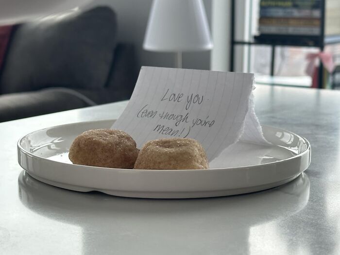 Plate with two cinnamon rolls and note saying love you even though you're mean showing wholesome love