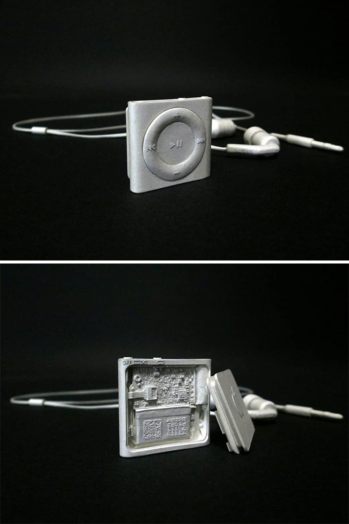 Paper iPod Shuffle and earphones with open back showing circuitry