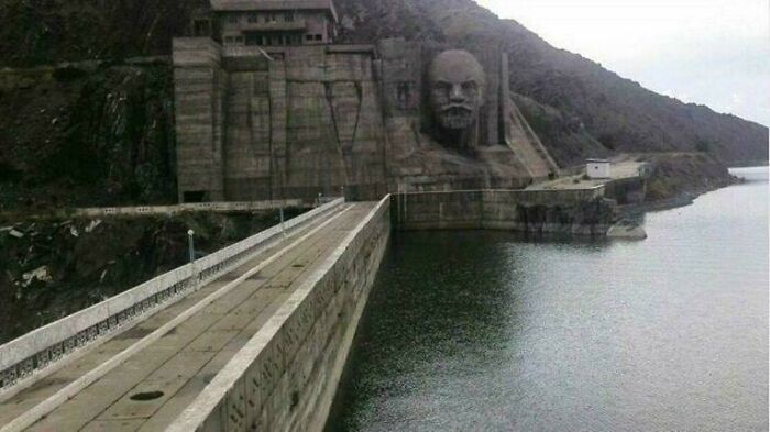 A massive dam with a carved face, part of the buildings for an evil mastermind's world conquest plans.
