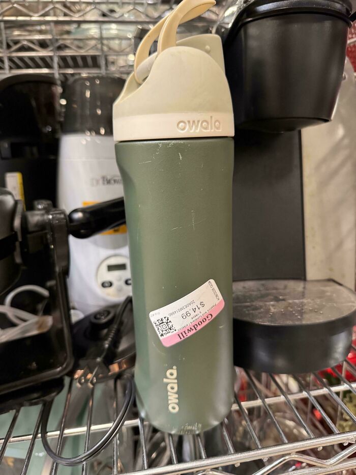 A used Owala water bottle with a Goodwill price tag, indicating consumerism trends and price difference.