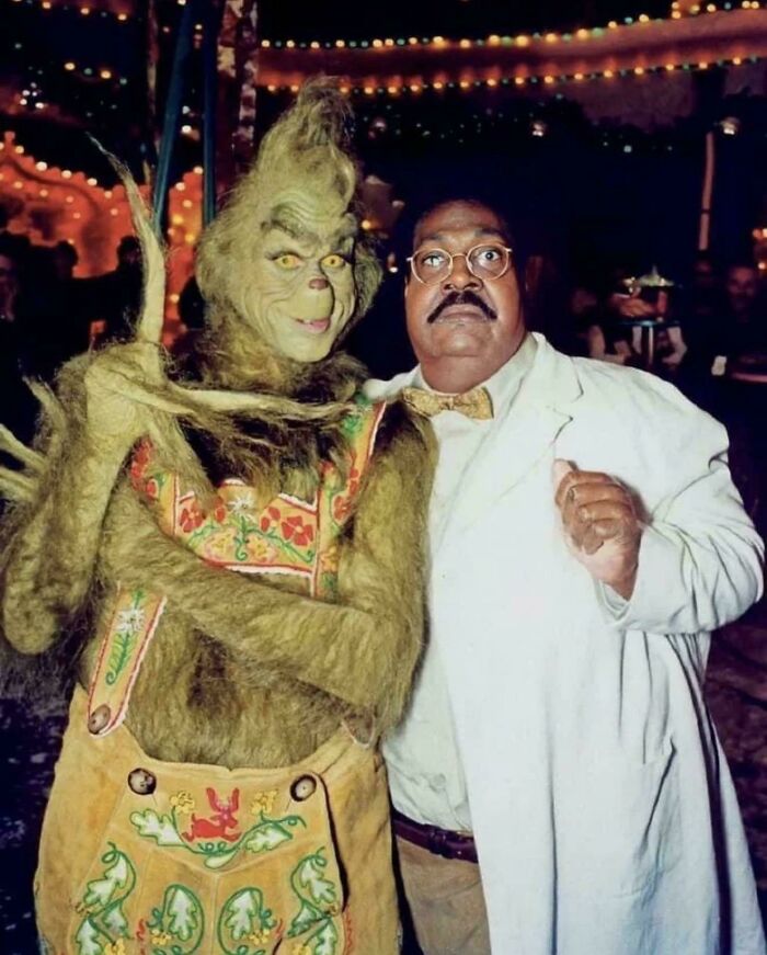 Uplifting posts: The Grinch in a costume posing with a man in a white lab coat and bow tie, an uplifting and interesting post.