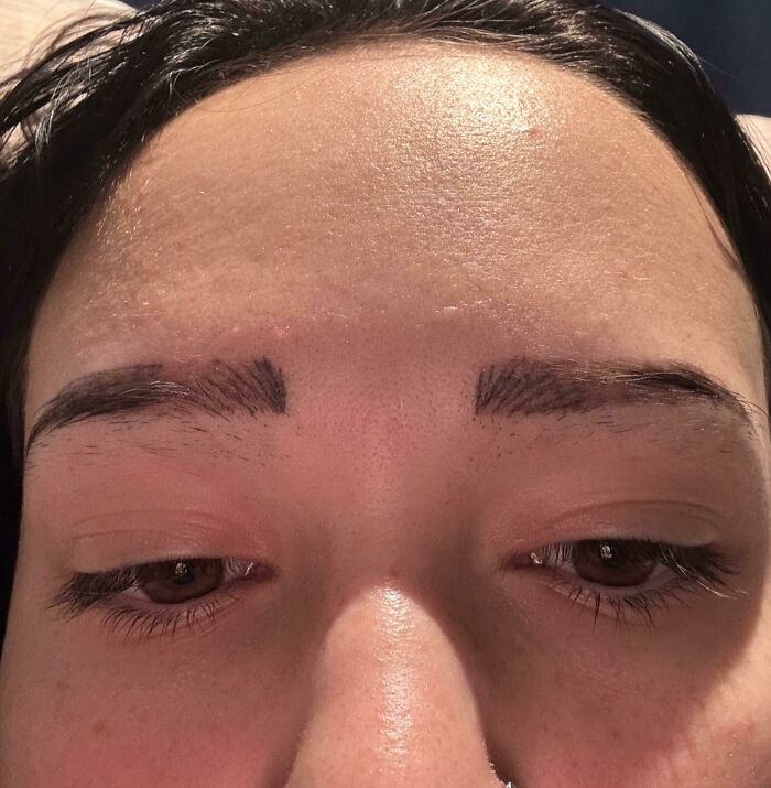 A close-up of a person's face showing uneven and poorly drawn eyebrows, a common beauty disaster.