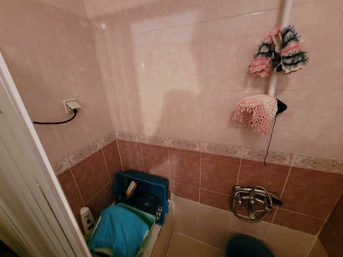 Cluttered and cramped bathroom corner with limited space