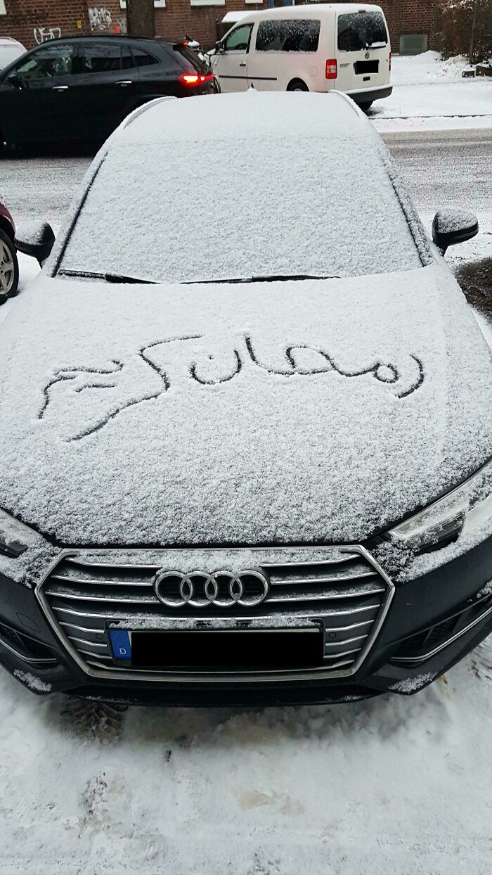A snowy Audi car with Arabic script written on the hood, representing something interesting on the "What Does This Mean?" group.