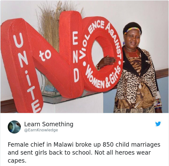A Malawian female chief stands beside a large red NO sign, promoting the end of violence against women and girls. Wholesome pics.
