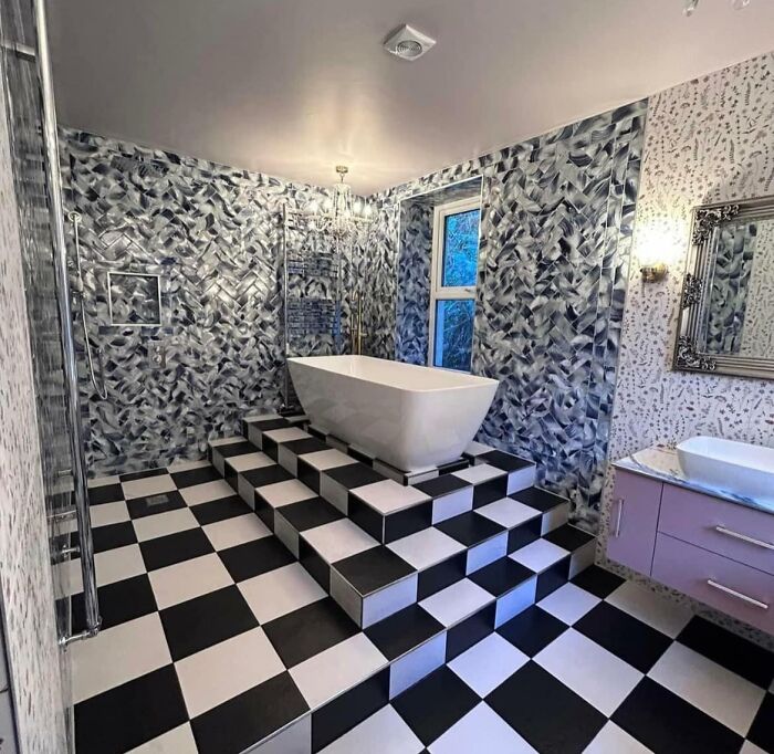 Bathroom with checkered floor and raised bathtub steps