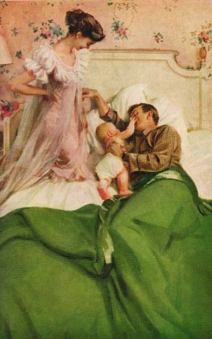 Wholesome picture of a mother watching her baby playfully touch his father's face in bed, evoking heartwarming emotions.