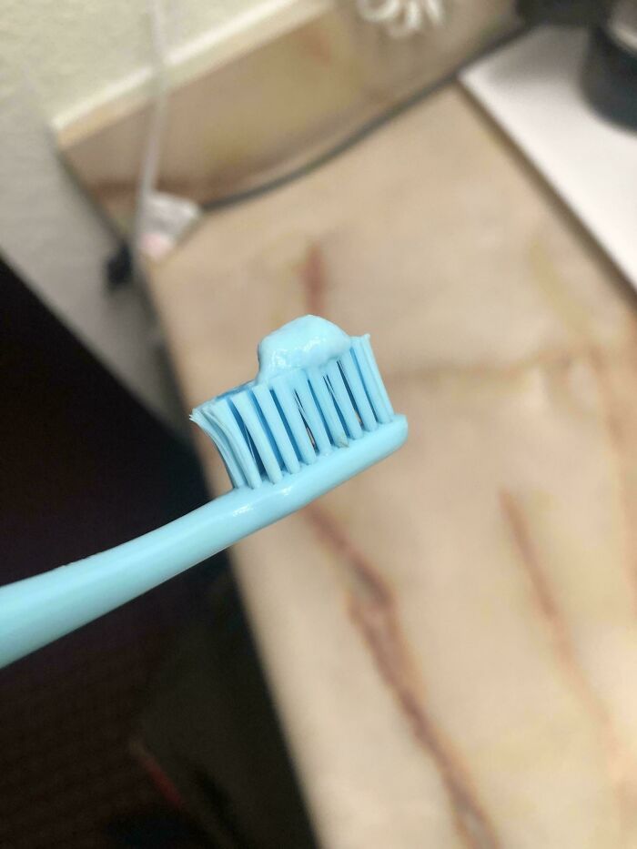 A light blue toothbrush with light blue toothpaste for an accidental color match that may lower your cortisol levels.