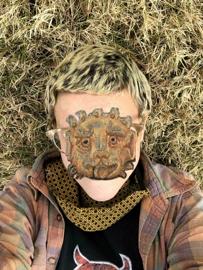 Person lying on dry grass, with blond hair and a plaid shirt, showcasing an accidental color match. Satisfying photos.