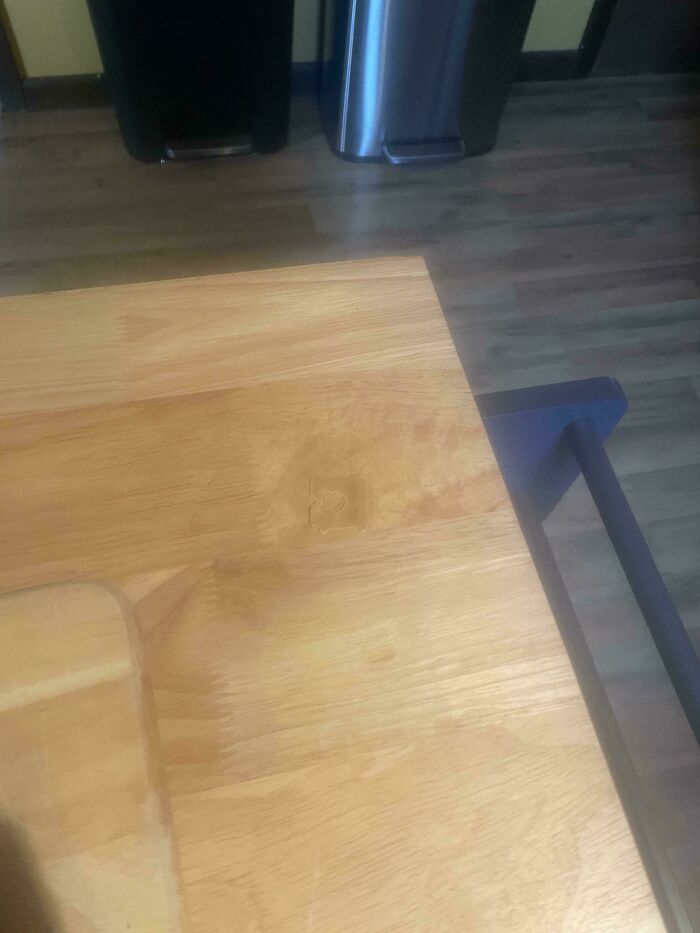 A light wooden countertop with a faint imprint of a mug, creating an accidental color match and a satisfying photo.