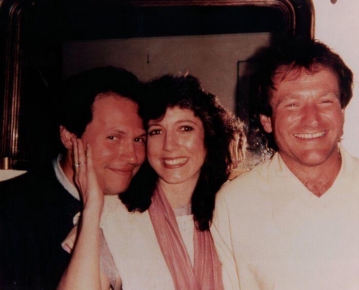 Three smiling people, including Robin Williams on the right, show a wild celebrity encounter.