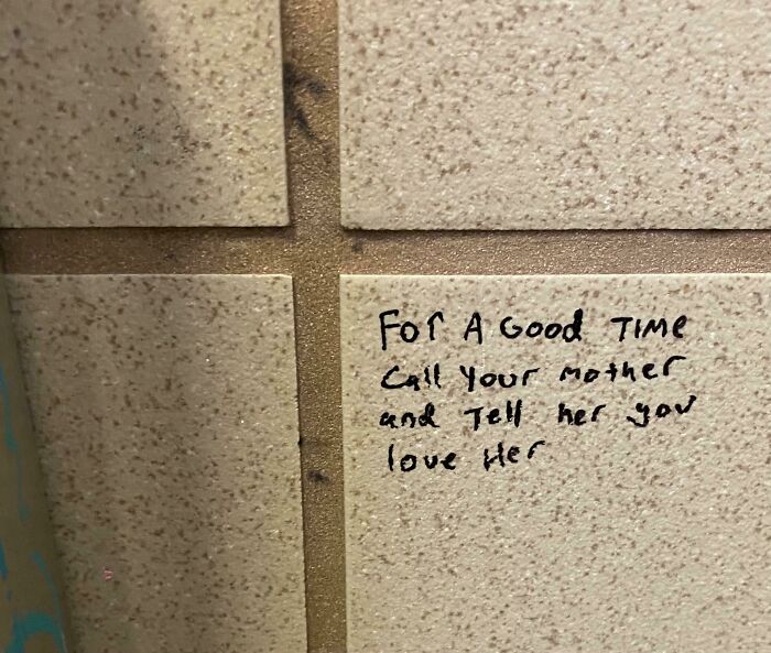 Wholesome pics: a bathroom stall message on tiles reads, "For a good time call your mother and tell her you love her."