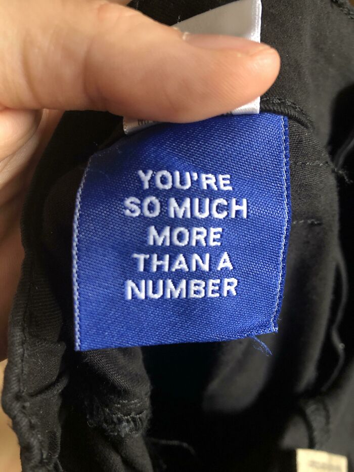 A hand holds a clothing tag that says You're so much more than a number. A wholesome pic with a powerful message.