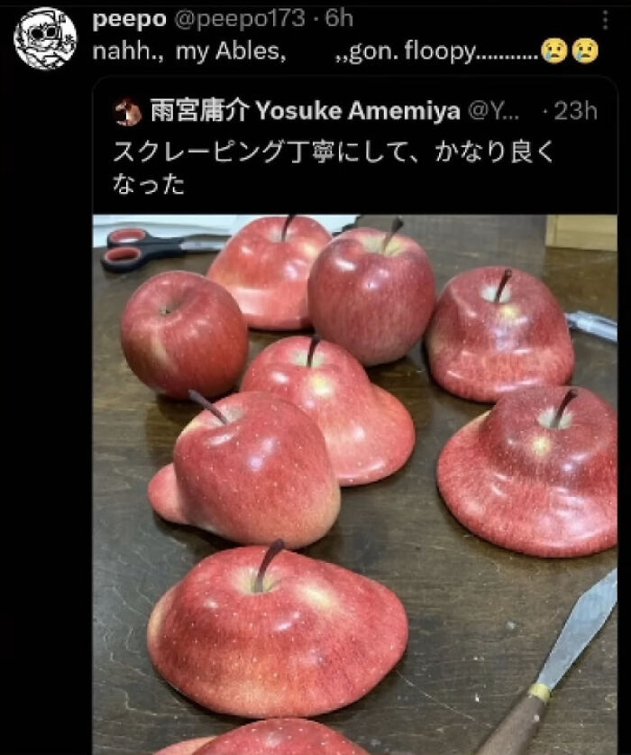 A collection of red apples with unusual, flattened and distorted shapes, almost as if they had a stroke.