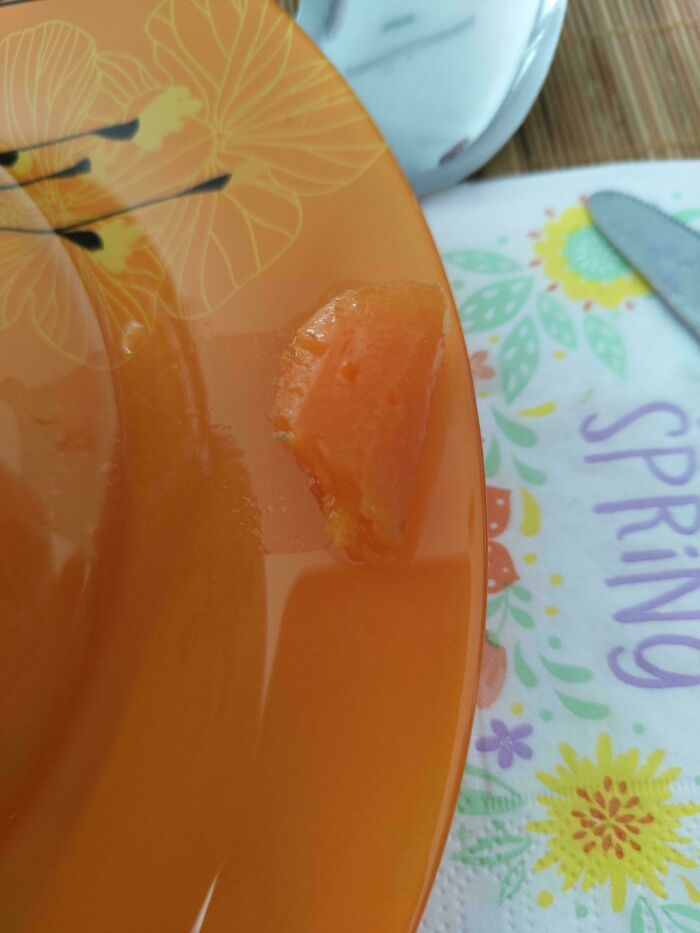 A piece of orange fruit on an orange plate with orange juice. An accidental color match that may lower your cortisol levels.