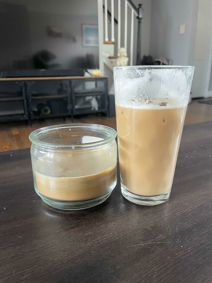Two glasses of iced coffee on a dark wooden table, an accidental color match that may lower your cortisol levels.