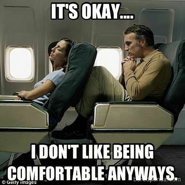Man squished by another passenger's feet on a plane, relatable for travel memes about uncomfortable flights.