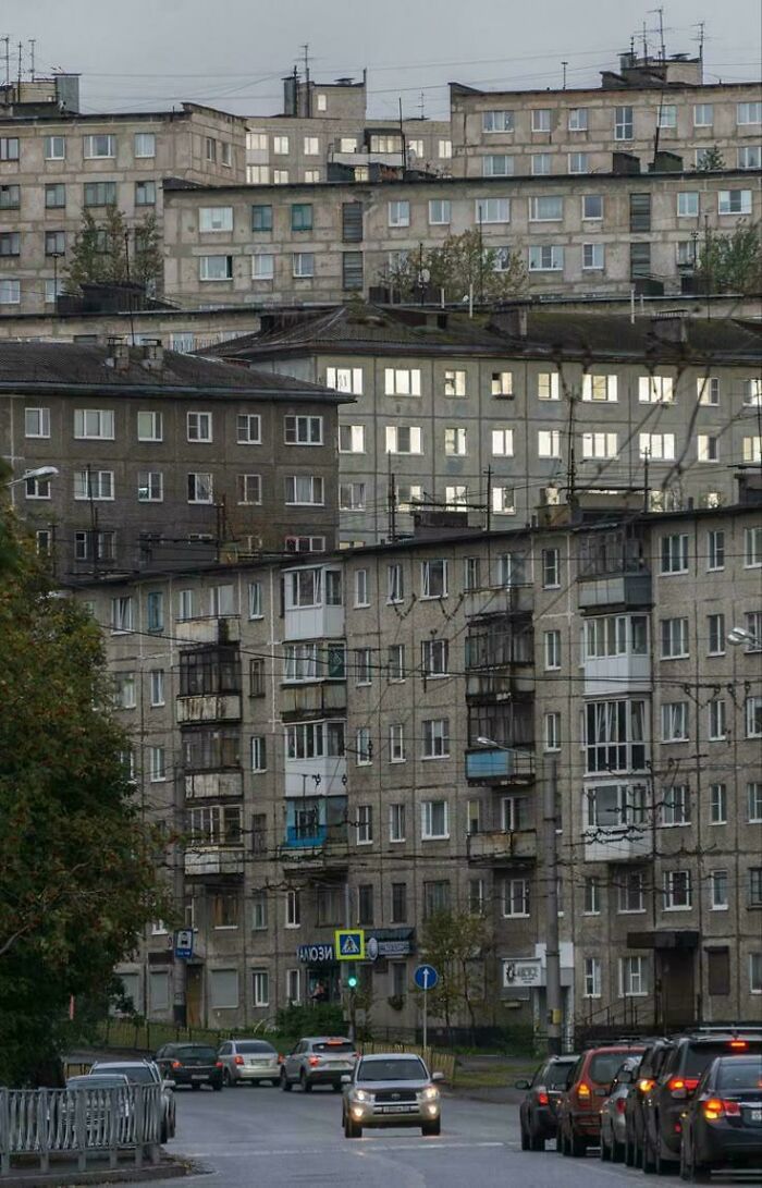 Gray urban hell apartment blocks with traffic on gloomy day
