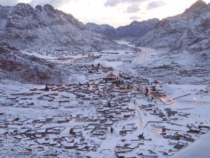Snowy village nestled in a mountainous area with breathtaking stunning views
