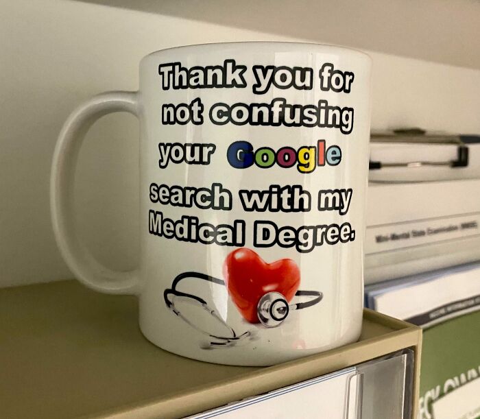 A white mug with a doctor's awesome sense of humor, featuring text about Google searches and a medical degree.