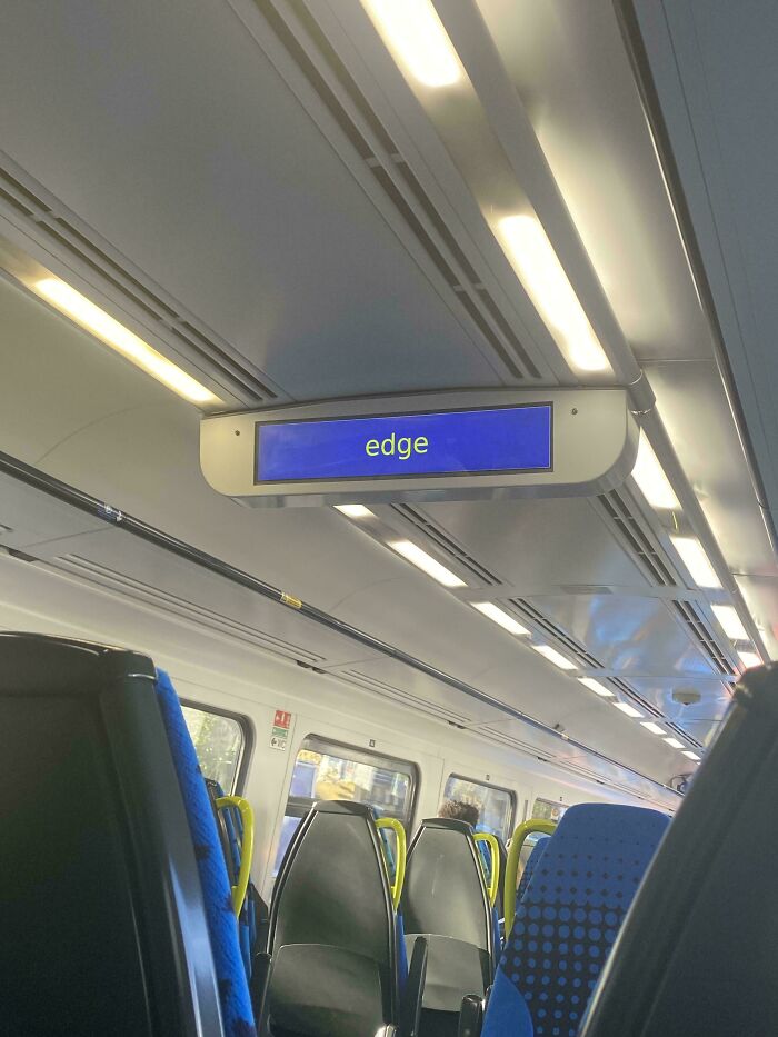 Train interior with an electronic display showing "edge," a humorous example of premature truncation.