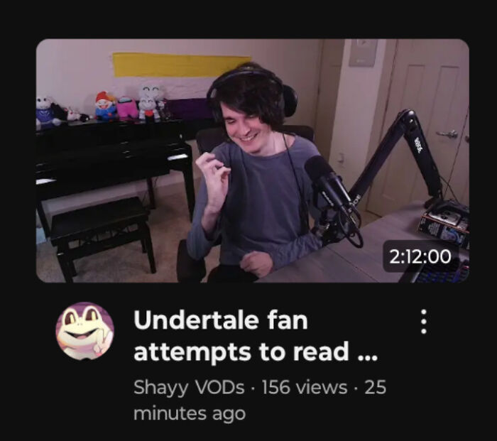 A person with dark hair, wearing headphones and a gray shirt, smiles while speaking into a microphone. This image could be related to premature truncation.