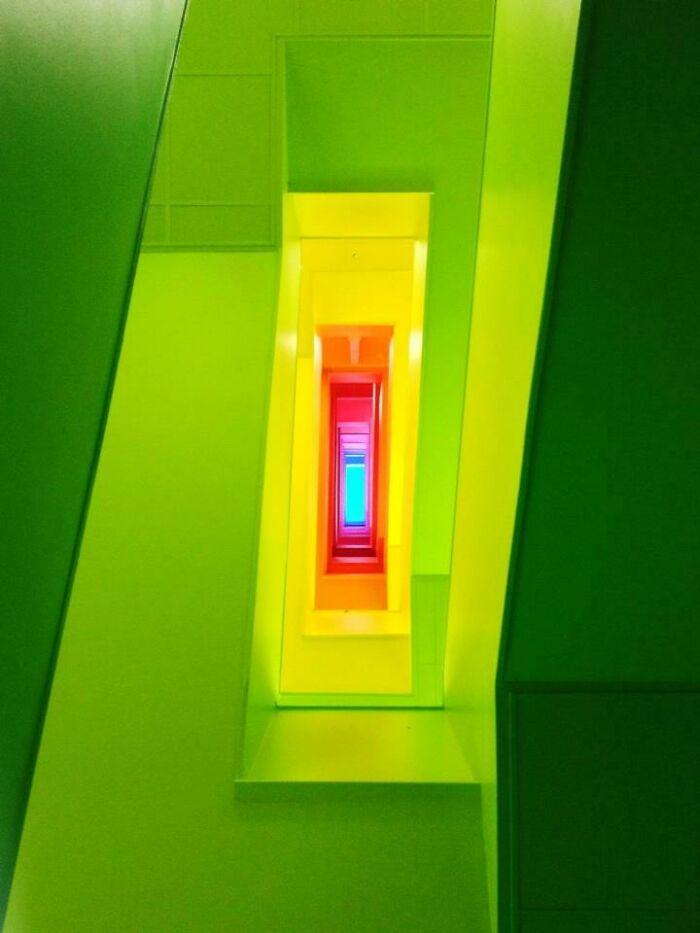Colorful spiral stairwell viewed from below in school building