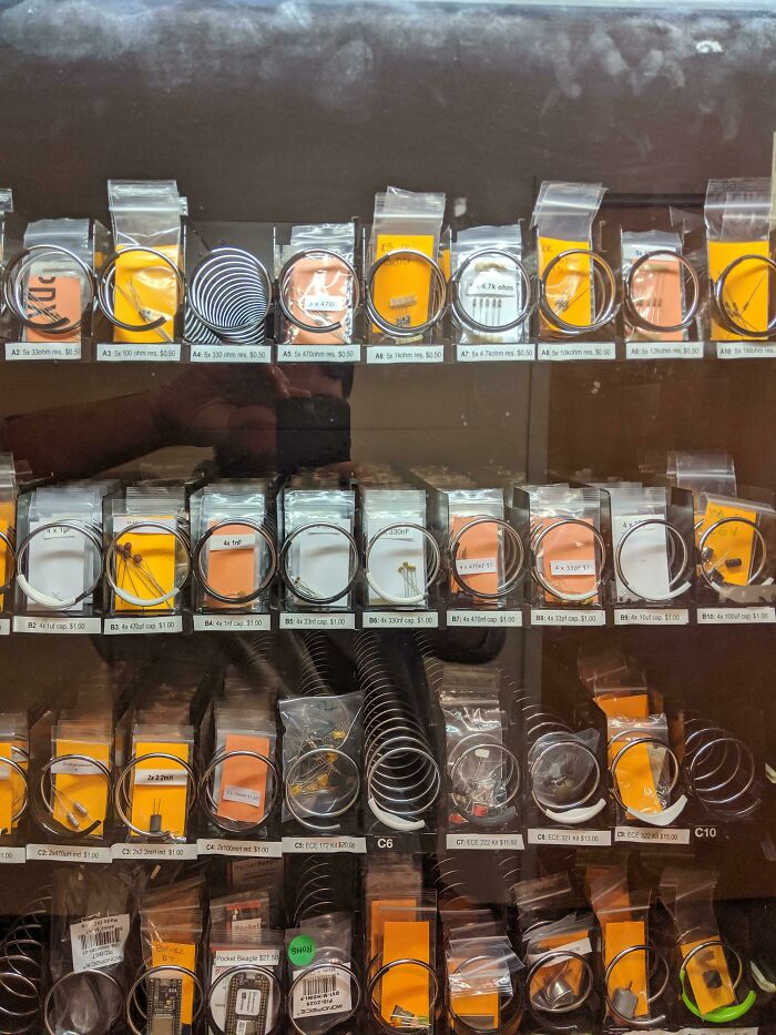 Electronics vending machine with resistors and capacitors in a school setting