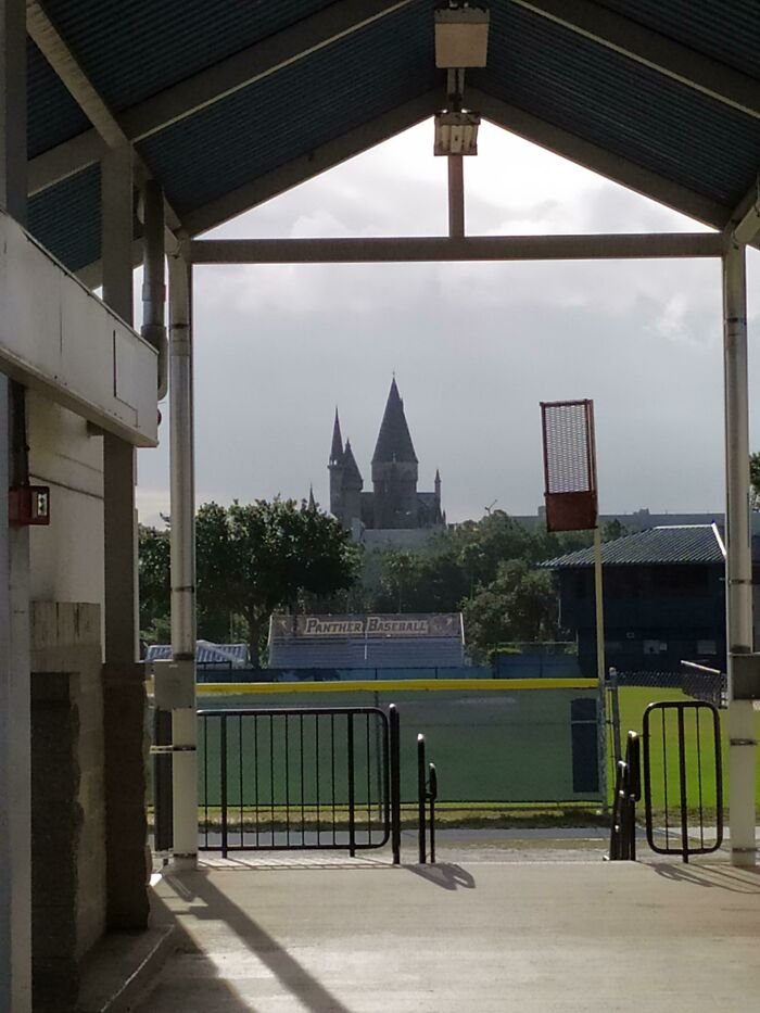 View of campus baseball field and castle-like building framed by pavilion