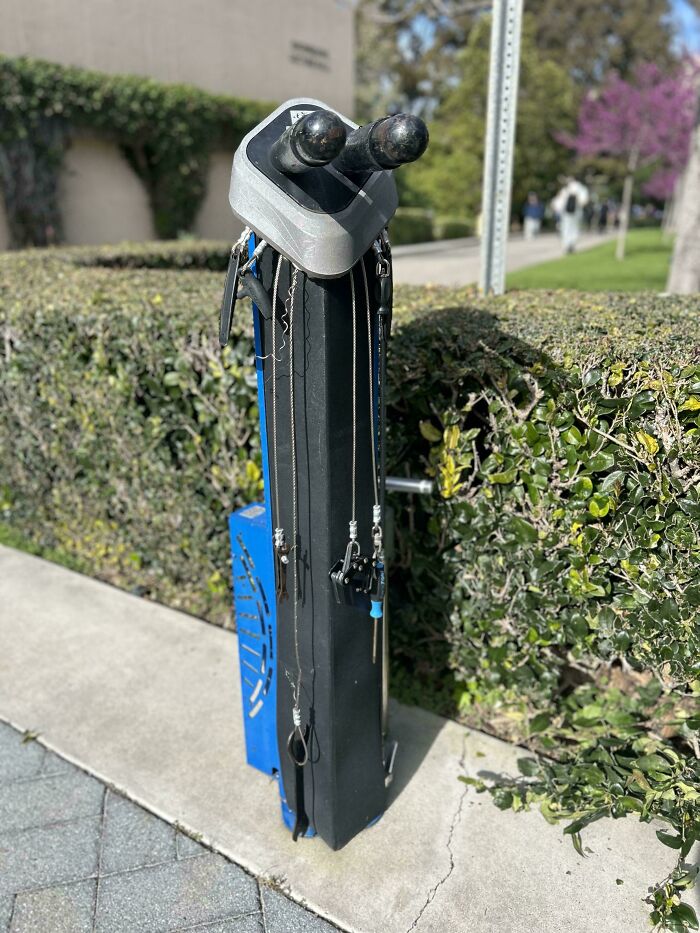 Fishing rod rack installed outdoors on college campus sidewalk