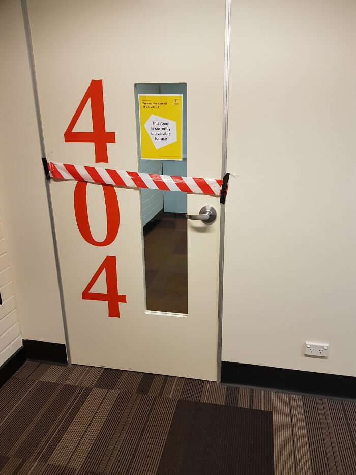 Classroom door number 404 taped off with COVID-19 unavailable use sign