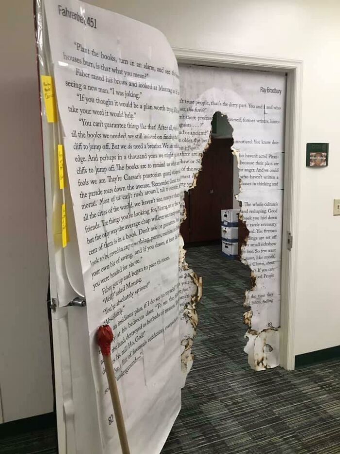 Classroom door decorated with Fahrenheit 451 book pages and burnt edges