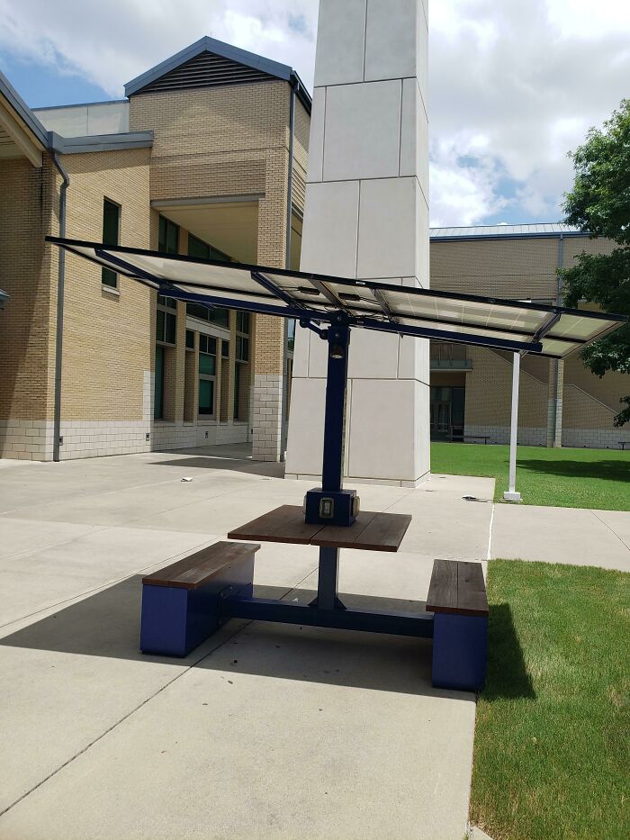 Outdoor school picnic table with solar panel canopy providing shade