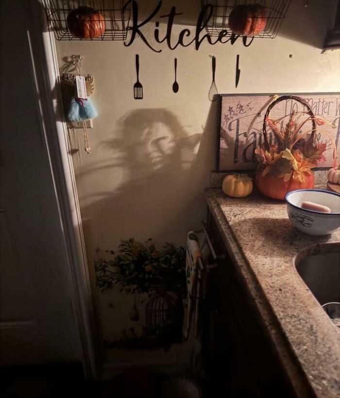 Kitchen shadow creates a face illusion on the wall