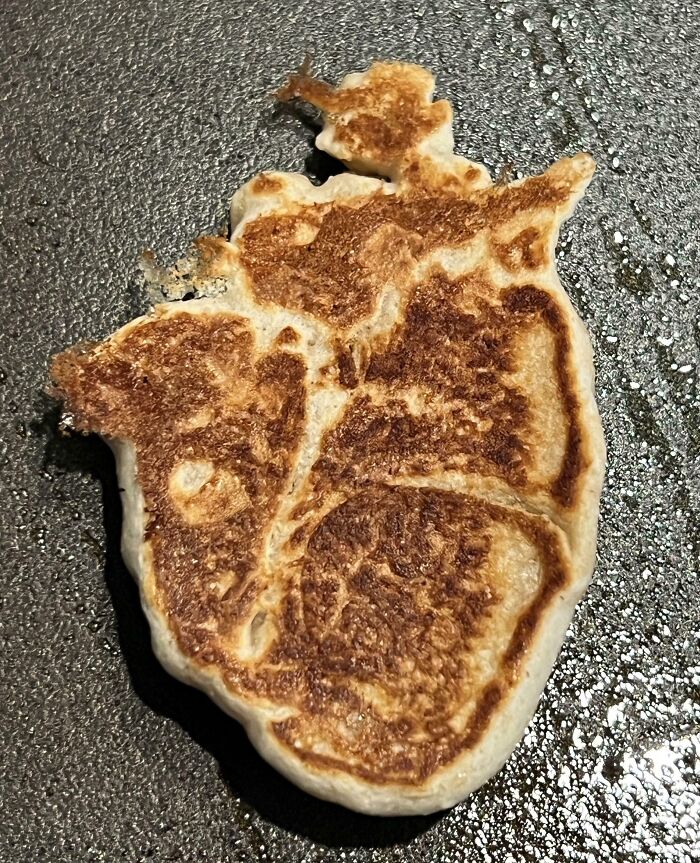 Pancake on griddle resembling an anatomical heart in pareidolia