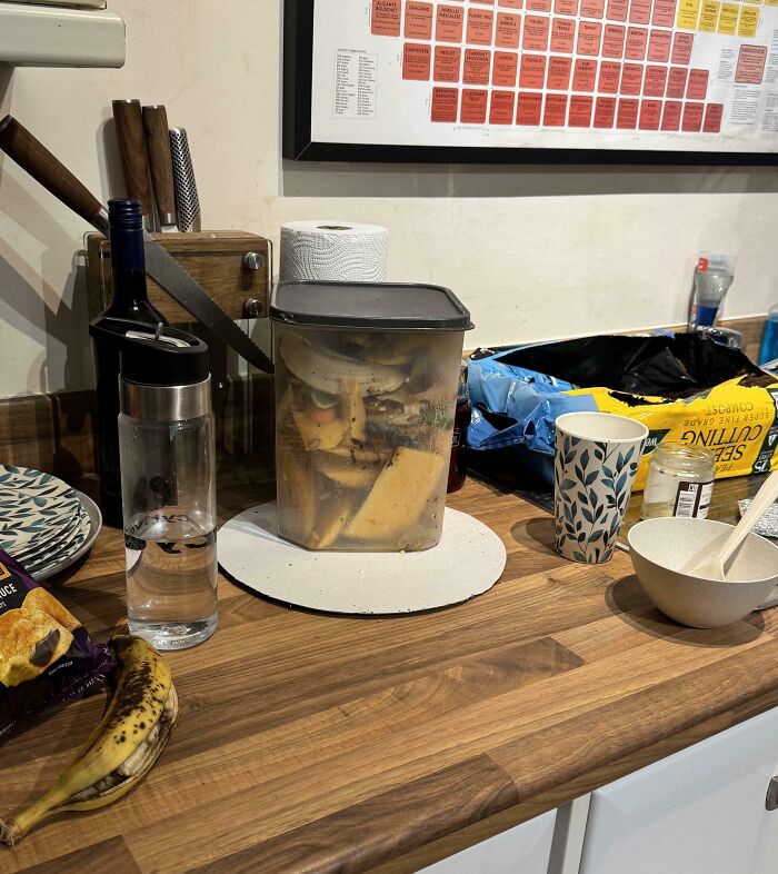 Kitchen counter clutter with container showing face-like pattern