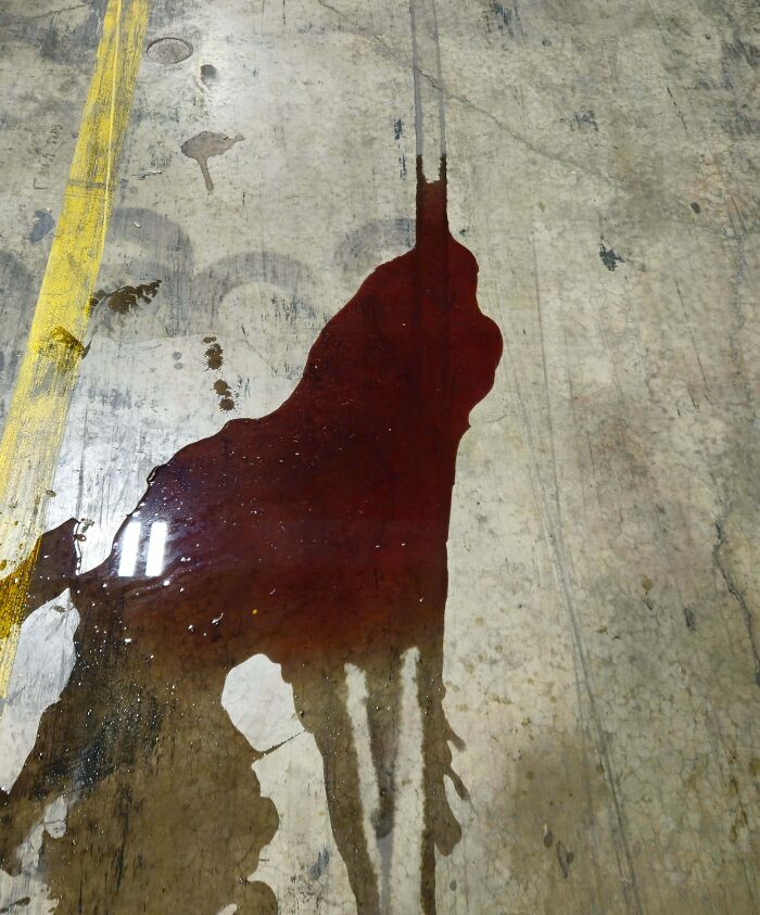 Spilled liquid on floor forming an outline resembling a person