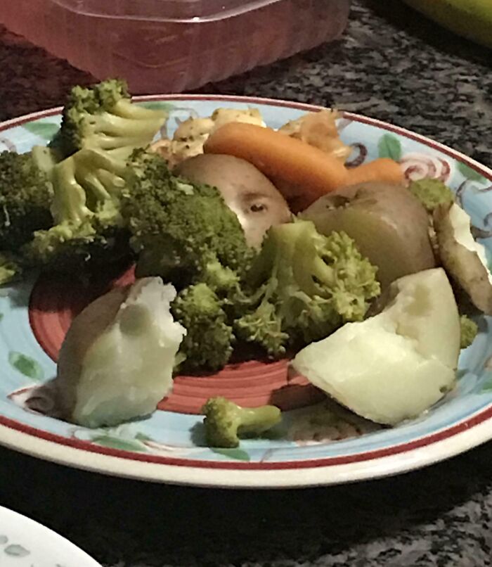Pareidolia face seen among broccoli and potatoes on plate