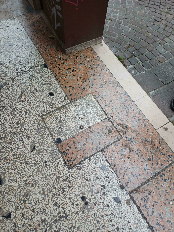 Funny you had one job fail: a square manhole cover on a patterned sidewalk is placed incorrectly, breaking the design.